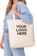 Person holding a tote bag with 'Your Logo Here' text